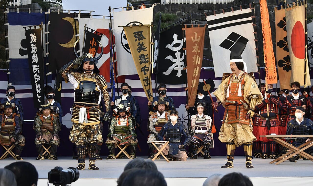 Actors in samurai armour re-enact the war council scene on stage at Maizuru Castle Park during the Shingen-ko Festival