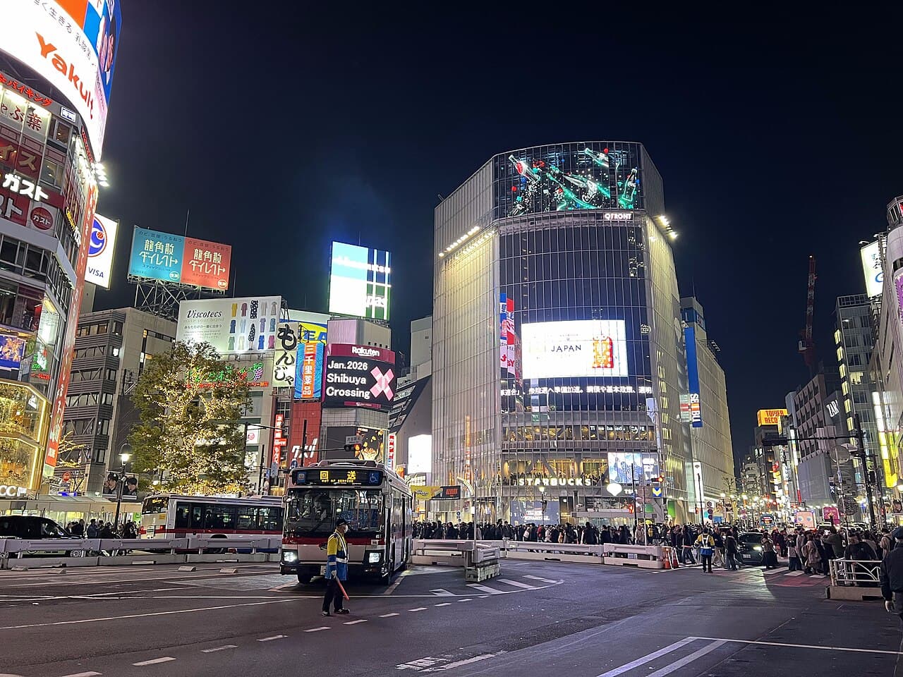 The Shibuya Scramble Crossing lit up at night in Tokyo