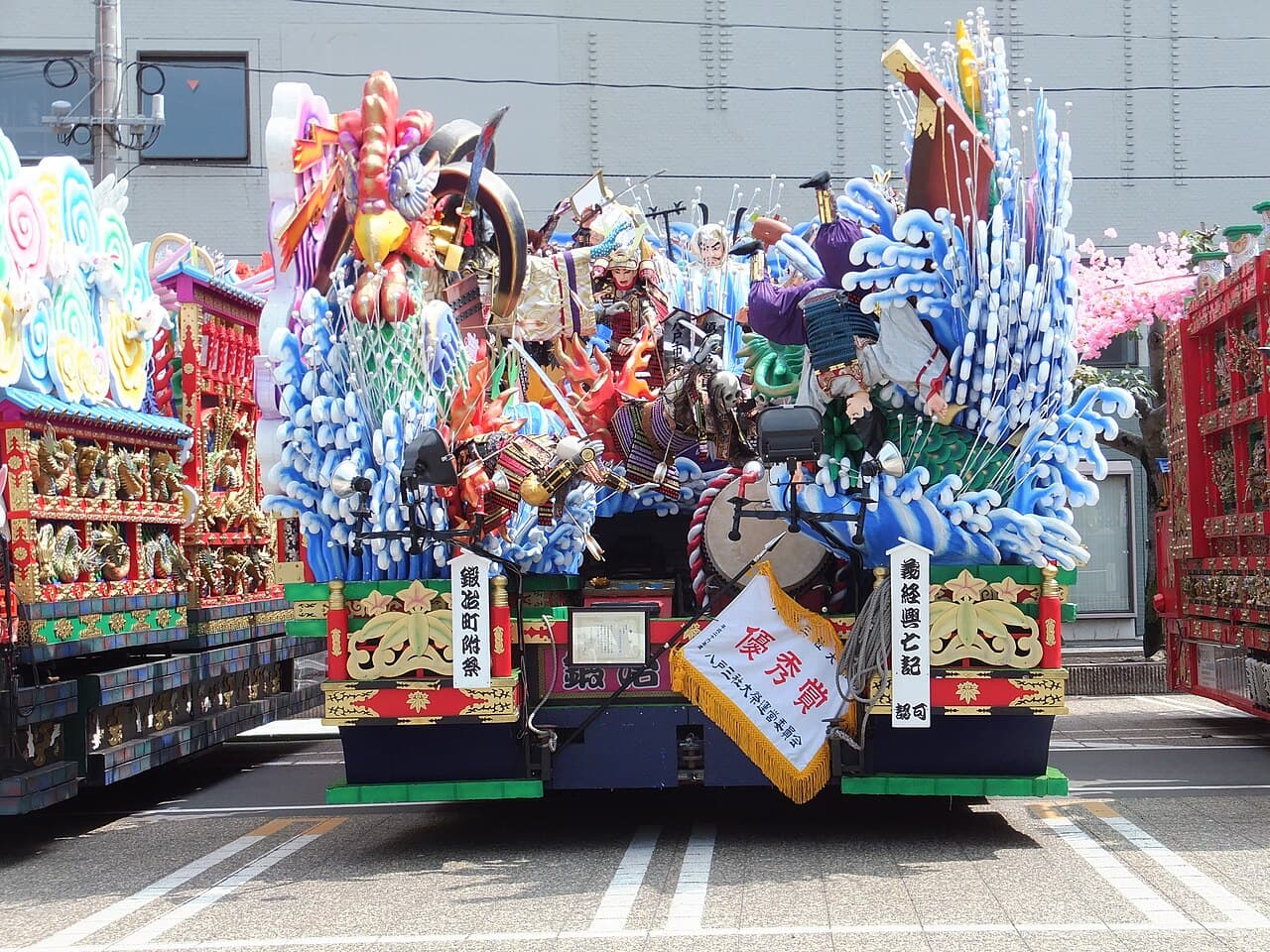 A towering, elaborately decorated float (dashi) of the Hachinohe Sansha Taisai on parade through the city