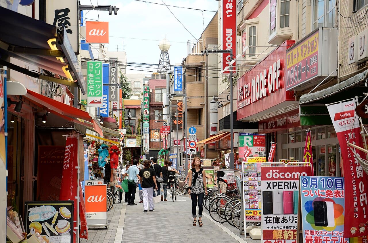 A narrow, densely packed shopping street in the Shimokitazawa district of Tokyo