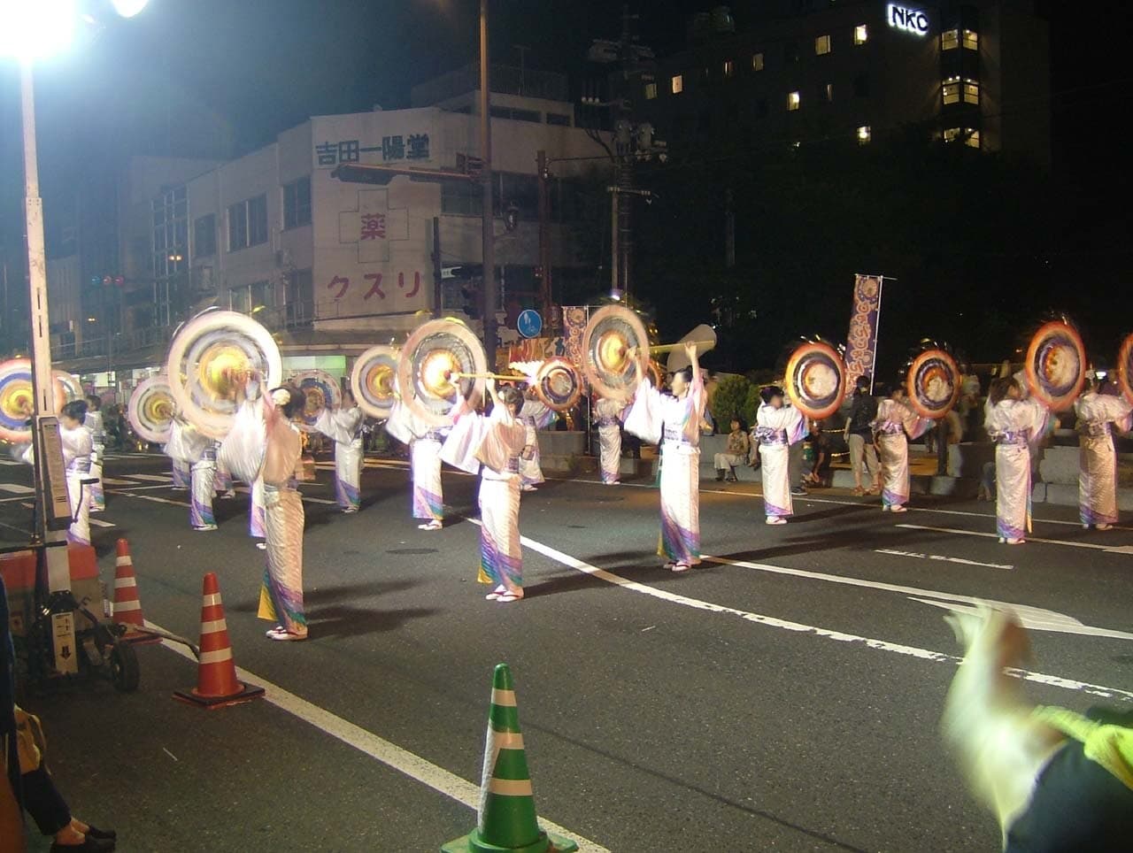 Dancers with bell-hung umbrellas cross Wakasa Bridge during the Tottori Shan-Shan Matsuri