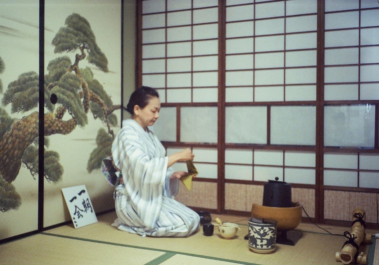 Host preparing matcha during a Japanese tea ceremony in Kyoto